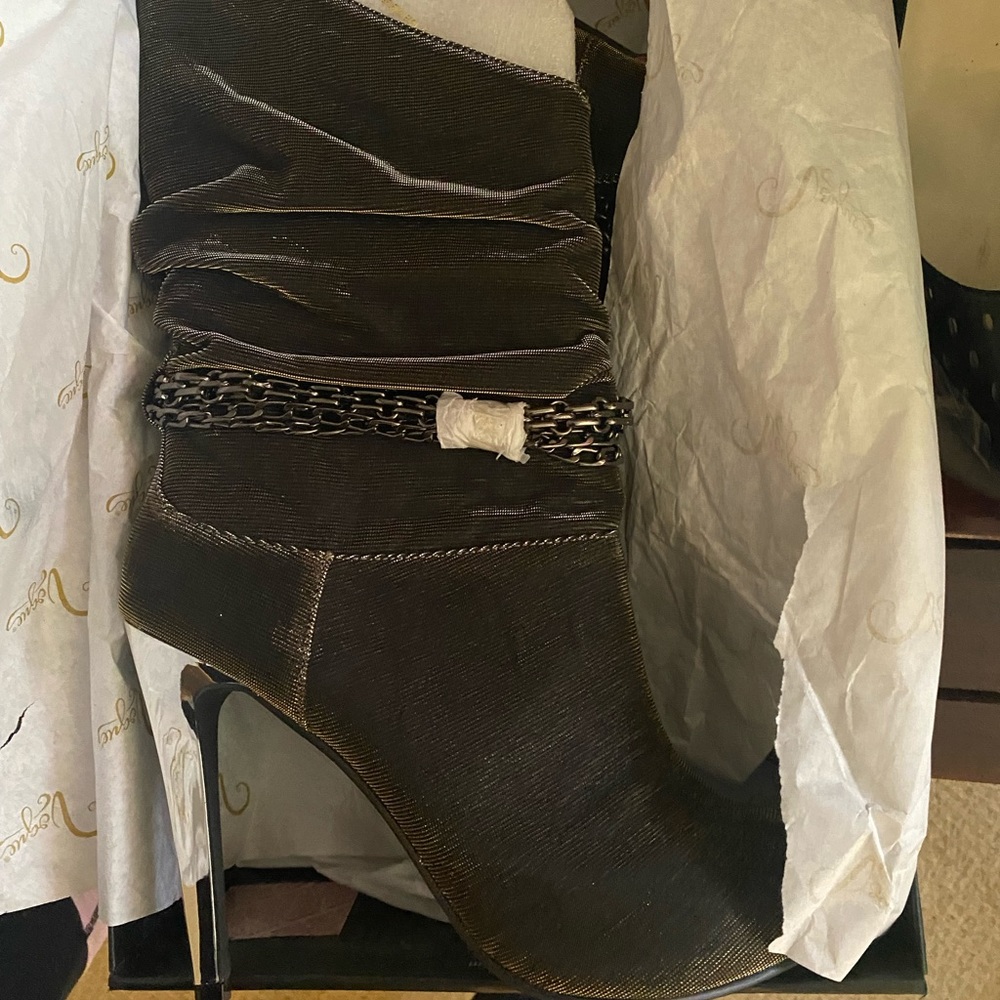 Women’s size 9 boots. They have hints of gold and silver. New/never worn.
